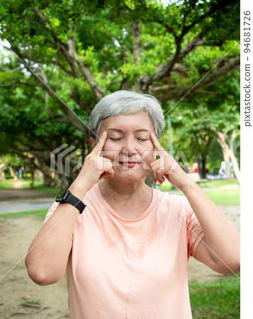 A 60-year-old Asian mature woman with a massage eye, enjoying the fresh air of nature in the park. A 60-year-old Asian mature woman with a massage eye, enjoying the fresh air of nature in the park. 94681726