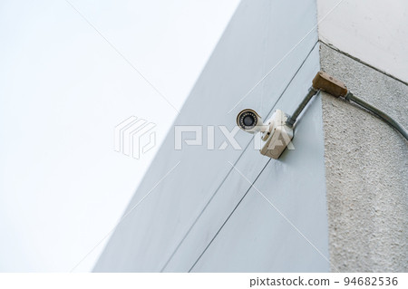 Modern CCTV camera against city and sky background. surveillance, video record and monitoring concept Modern CCTV camera against city and sky background. surveillance, video record and monitoring concept 94682536
