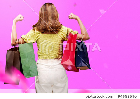 Rear view of an Asian woman carrying a shopping bag Rear view of an Asian woman carrying a shopping bag 94682680