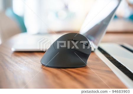 ergonomic mouse on desk at workplace, prevention wrist pain because working long time. De Quervain s tenosynovitis, Intersection Symptom, Carpal Tunnel Syndrome or Office syndrome concept 94683903