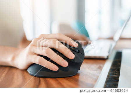 woman hand using computer ergonomic mouse, prevention wrist pain because working long time. De Quervain s tenosynovitis, Intersection Symptom, Carpal Tunnel Syndrome or Office syndrome concept 94683924