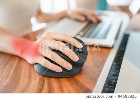 woman hand using computer ergonomic mouse, prevention wrist pain because working long time. De Quervain s tenosynovitis, Intersection Symptom, Carpal Tunnel Syndrome or Office syndrome concept woman hand using computer ergonomic mouse, prevention wrist pain because working long time. De Quervain s tenosynovitis, Intersection Symptom, Carpal Tunnel Syndrome or Office syndrome concept 94683926