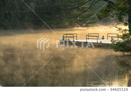 A boat dock in a park shrouded in an air storm A boat dock in a park shrouded in an air storm 94685529