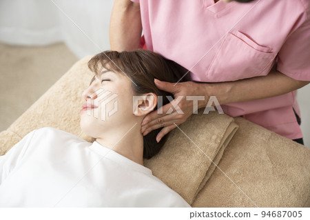 A young woman receiving a massage A young woman receiving a massage 94687005