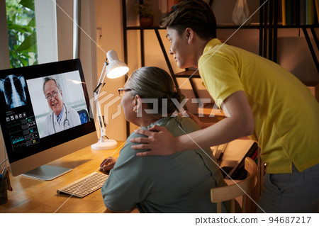 Grandmother and grandson using telemedicine service to get consultation of doctor 94687217