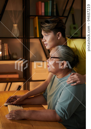 Grandmotehr and grandson searching for information on internet 94687219