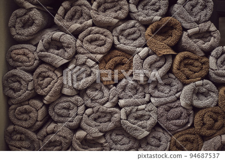 Clean towels on the shelf in barbershop. 94687537