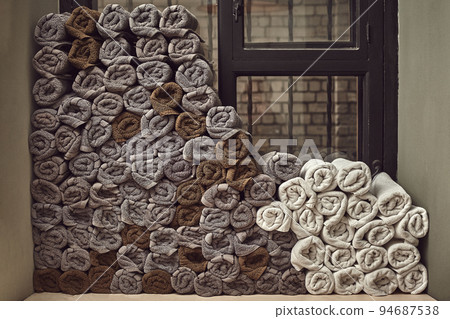 Clean towels on the shelf in barbershop. 94687538