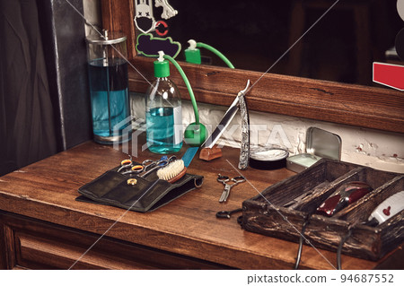 Barbershop tools on wooden brown table. Accessories for shaving and haircuts on the table. 94687552