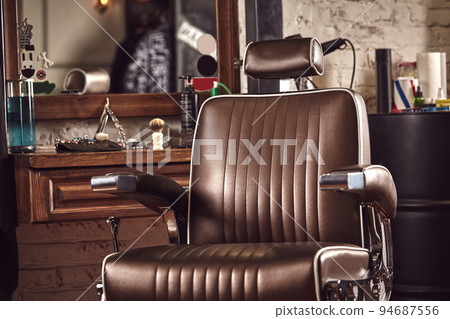 Barbershop armchair. Modern hairdresser and hair salon, barber shop for men. Barbershop armchair. Modern hairdresser and hair salon, barber shop for men. 94687556