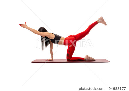 Slim woman doing yoga on mat Slim woman doing yoga on mat 94688177