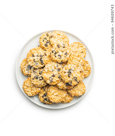 Wholegrain oat cookies. Cookies with oatmeal and raisins isolated on white table. 94689743