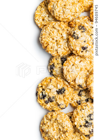 Wholegrain oat cookies. Cookies with oatmeal and raisins isolated on white table. 94689745