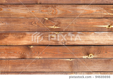 The texture of the wall of old and weathered wooden boards painted with brown paint. 94689898