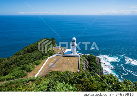 Cape Chikyu on a cliff surrounded by blue 94689916