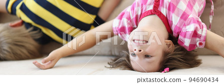 Children have fun at home, kids upside down on sofa, holiday at school Children have fun at home, kids upside down on sofa, holiday at school 94690434