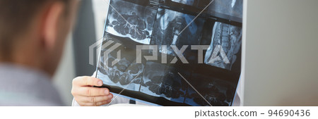 Doctor examining patients xray result in hospital on appointment with client 94690436
