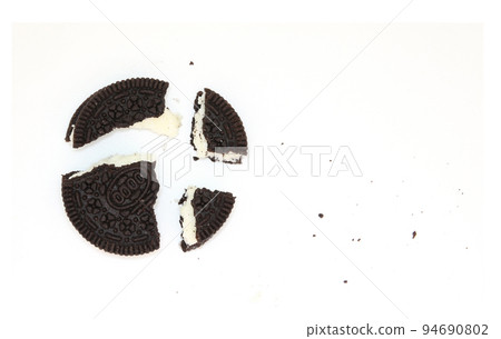 Sandwich chocolate cookies with a sweet cream with crumbs isolated on white background 94690802