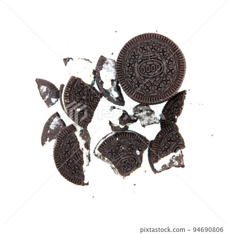 Sandwich chocolate cookies with a sweet cream with crumbs isolated on white background Sandwich chocolate cookies with a sweet cream with crumbs isolated on white background 94690806