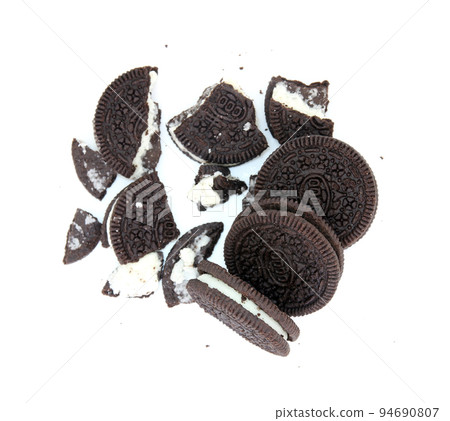 Sandwich chocolate cookies with a sweet cream with crumbs isolated on white background Sandwich chocolate cookies with a sweet cream with crumbs isolated on white background 94690807