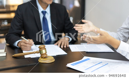 Client describes the money fraud problem and discusses the solution with a lawyer in the litigation room, Ethics in the courts include justice, legal consultant, Scales of justice, Litigation. 94691648