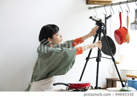 Young woman preparing for cooking livestream Young woman preparing for cooking livestream 94693330