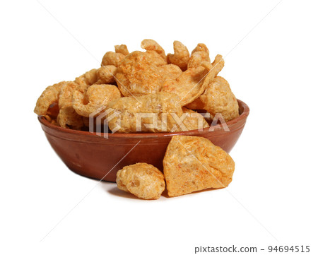 Bowl of Fried Pork Skins Isolated on White Background 94694515