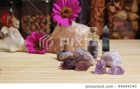 Amethyst Crystals With Flowers and Incense Cones on Meditation Table 94694540