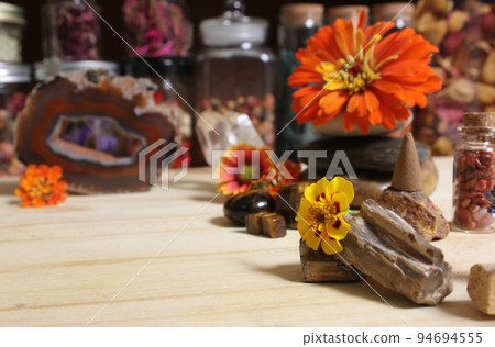 Agatized Coral With Quartz Crystals and Flowers on Meditation Table 94694555