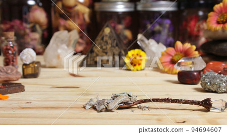 Sage in Vintage Spoon on Meditation Altar With Pyramid in Background 94694607