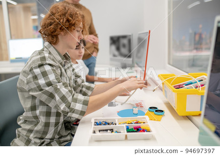 School boys having IT lesson and looking ivolved School boys having IT lesson and looking ivolved 94697397