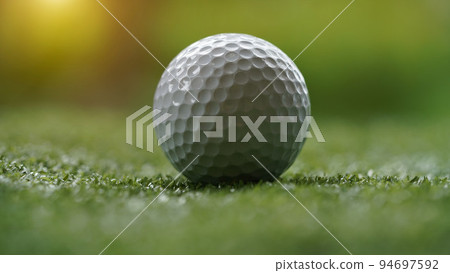 Golf ball on green grass with blur background. 94697592