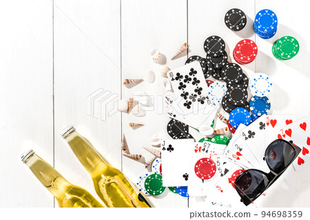 Gambling. Poker chips, cards and two bottles of beer on wooden table. Top view. Copyspace. Poker 94698359