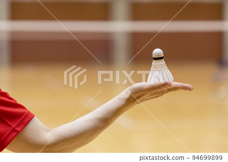 Badminton shuttlecock on the palm of a woman Badminton shuttlecock on the palm of a woman 94699899