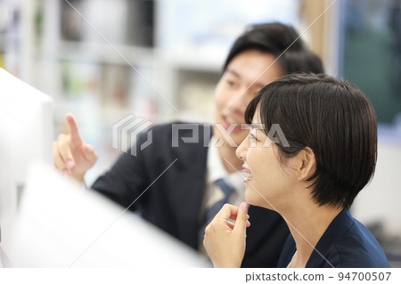 Business woman listening to advice smilingly 1 Business woman listening to advice smilingly 1 94700507