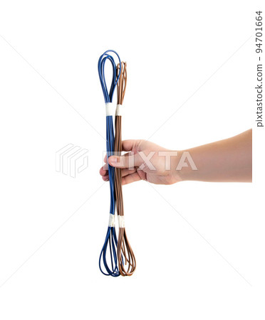 Wires with brown and blue insulation in a person's hand on a white background, isolate. Close-up Wires with brown and blue insulation in a person's hand on a white background, isolate. Close-up 94701664