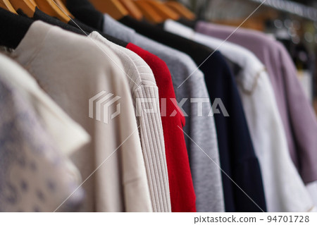 lots of clothes on hangers 94701728