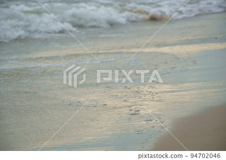salt water sea impact to beach with reflection of sunlight  94702046