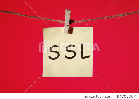 SSL Secure Sockets Layer concept text on a yellow sticker on a clothespin with a rope on a red background SSL Secure Sockets Layer concept text on a yellow sticker on a clothespin with a rope on a red background 94702397