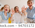 Happy mother with children, small son and daughter running towards 94703172