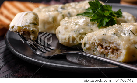 Traditional Lithuanian dish zeppelin, boiled potato dumplings stuffed with minced meat Traditional Lithuanian dish zeppelin, boiled potato dumplings stuffed with minced meat 94703742