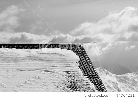 Roof of hotel in snow and winter mountains. Black and white. Roof of hotel in snow and winter mountains. Black and white. 94704231