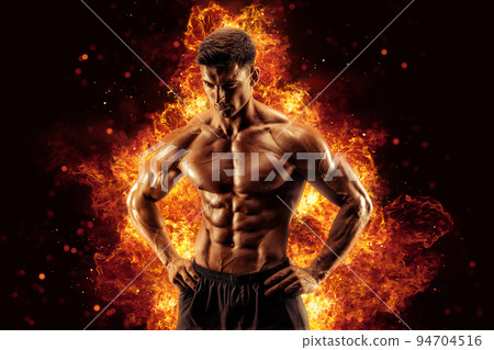 Bodybuilder posing on the fire flames background Bodybuilder posing on the fire flames background 94704516