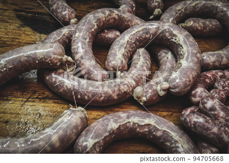 Handmade pork sausages finished on the table. Handmade pork sausages finished on the table. 94705668