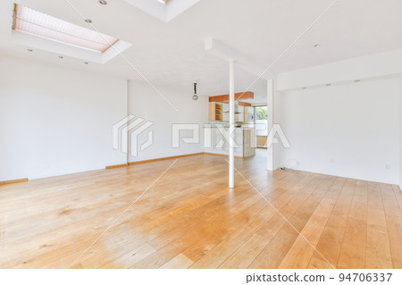Interior of empty white kitchen with windows and wooden parquet floor 94706337