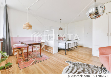 Home interior design of bedroom with bed and wooden wardrobe placed in corner near window in modern apartment Home interior design of bedroom with bed and wooden wardrobe placed in corner near window in modern apartment 94706672