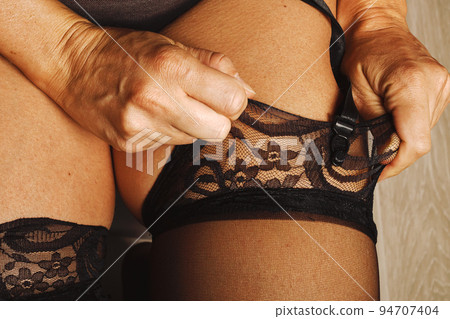 Woman pulling up her black stockings with high - Stock Photo [94707404]  - PIXTA