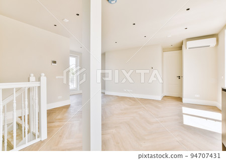 Interior of empty white room with large balcony windows with curtains and wooden parquet floor Interior of empty white room with large balcony windows with curtains and wooden parquet floor 94707431