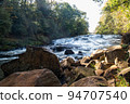A mountain stream waterfall photographed from downstream with a slow shutter speed 3 94707540