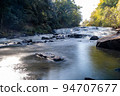A mountain stream waterfall photographed from downstream with a slow shutter 2 94707677